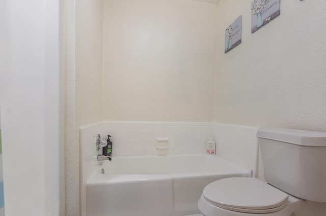 full bathroom with toilet and a garden tub