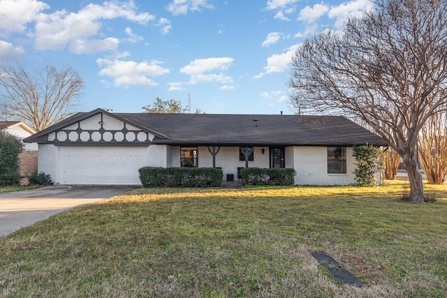 view of front facade with a front lawn, brick siding, driveway, and an attached garage