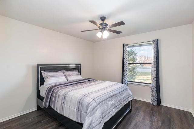 bedroom with a ceiling fan, baseboards, and wood finished floors