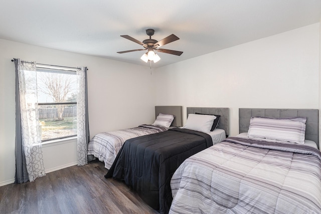 bedroom with a ceiling fan, baseboards, and wood finished floors