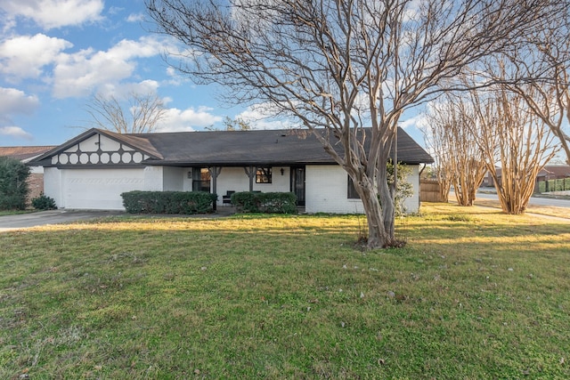 ranch-style home with a garage, driveway, a front yard, and brick siding