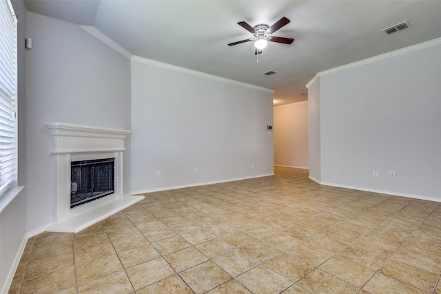 unfurnished living room with ceiling fan, visible vents, a fireplace with raised hearth, and ornamental molding