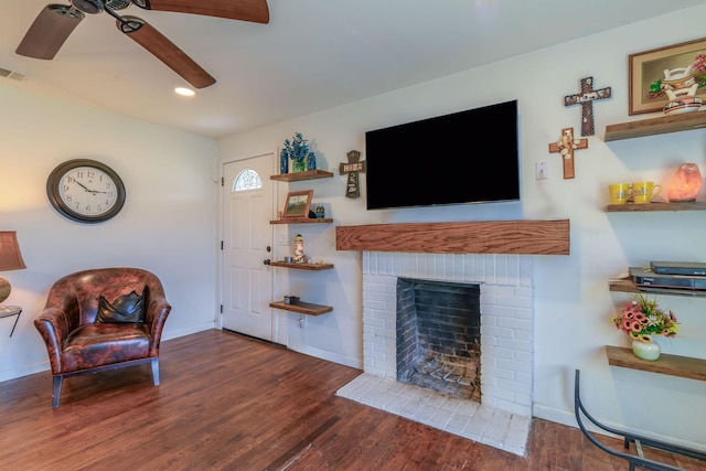 living area with a fireplace, recessed lighting, a ceiling fan, wood finished floors, and baseboards