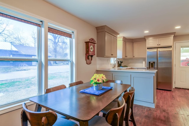 dining room with light wood finished floors and recessed lighting