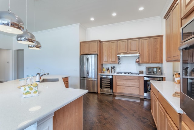 kitchen featuring beverage cooler, light countertops, appliances with stainless steel finishes, and a sink