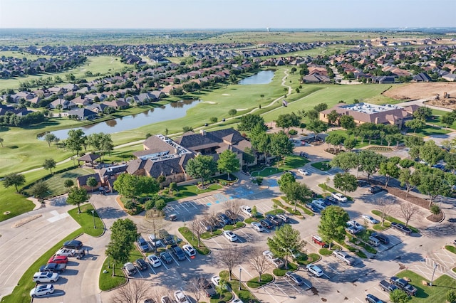 aerial view featuring a residential view, view of golf course, and a water view