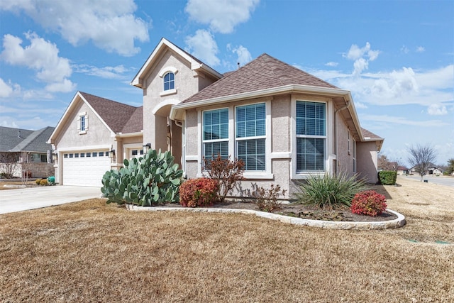 traditional-style home with roof with shingles, concrete driveway, and stucco siding