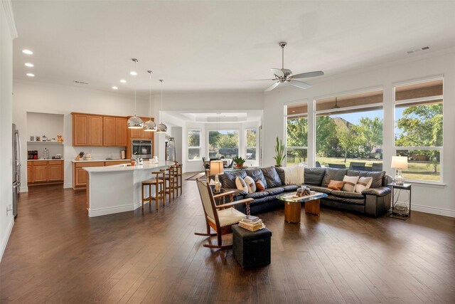 living room featuring baseboards, dark wood-type flooring, recessed lighting, and crown molding