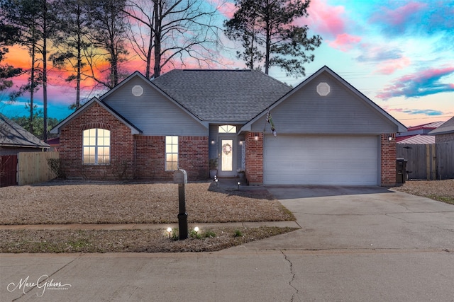 single story home with an attached garage, brick siding, a shingled roof, fence, and concrete driveway