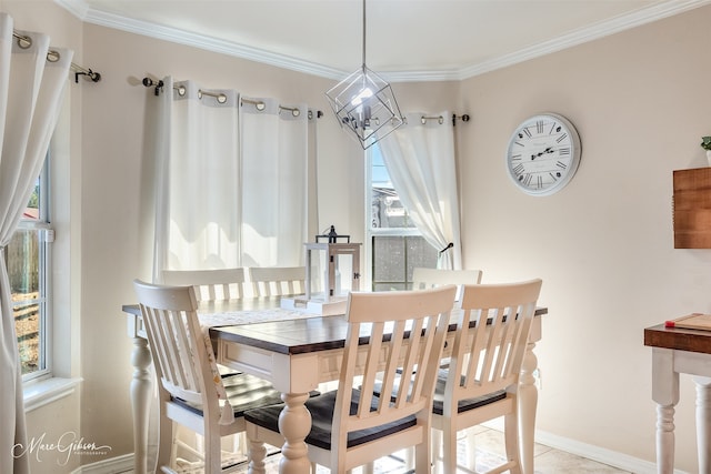 dining room with baseboards and crown molding