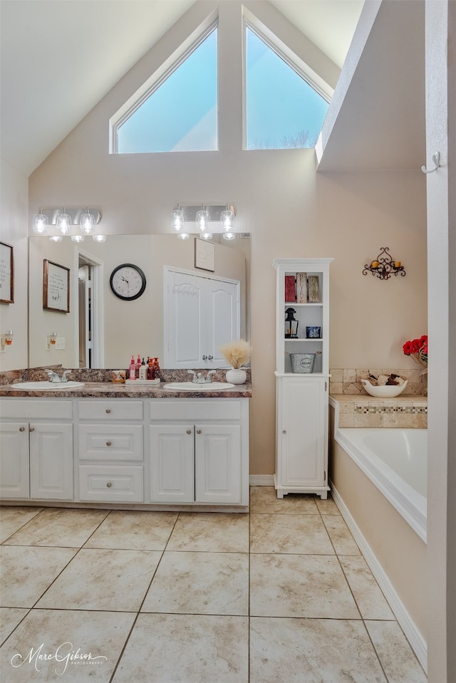 bathroom featuring high vaulted ceiling, tile patterned flooring, a sink, and double vanity