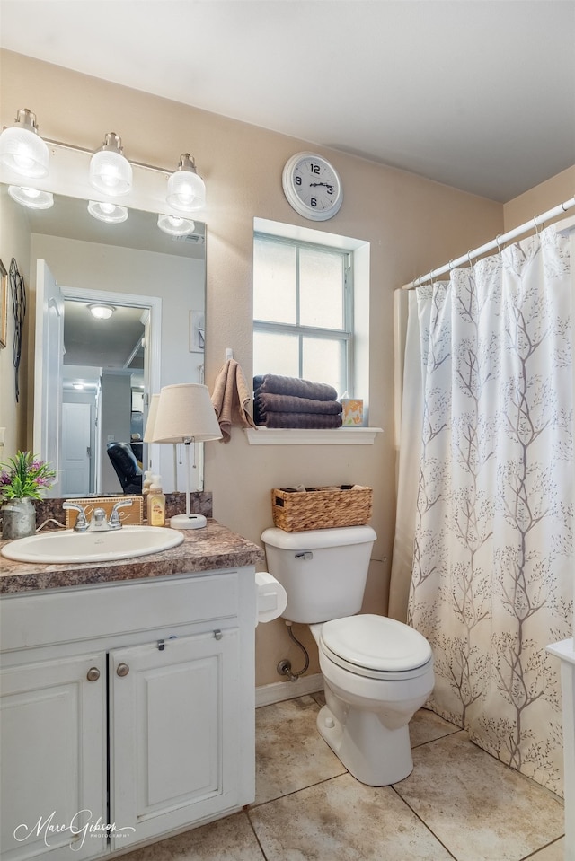 bathroom featuring a shower with curtain, vanity, toilet, and tile patterned floors