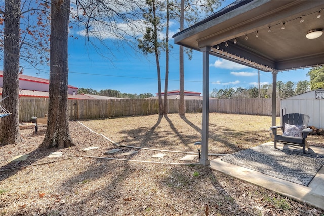 view of yard featuring a fenced backyard and an outdoor structure