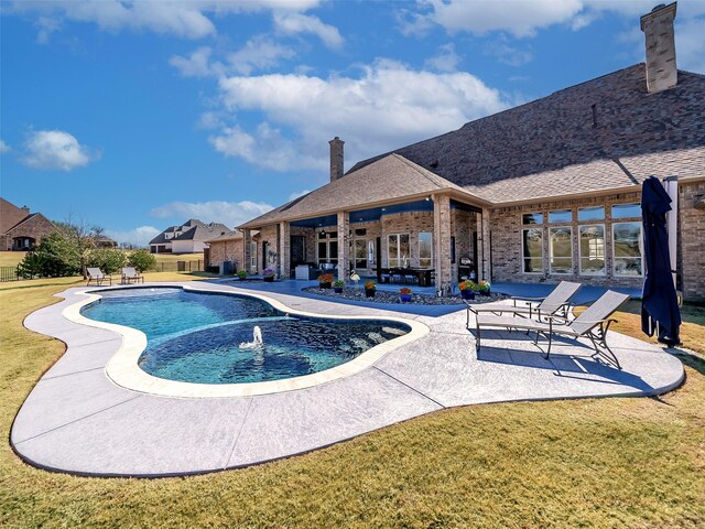 view of swimming pool featuring a patio area and a yard