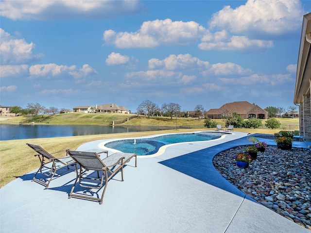 pool featuring a patio, a yard, and a water view