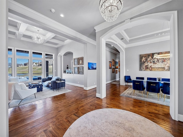 interior space featuring arched walkways, coffered ceiling, hardwood / wood-style floors, and an inviting chandelier