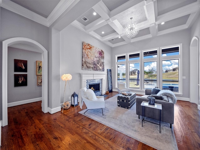 living area featuring wood finished floors, an inviting chandelier, a tile fireplace, and baseboards