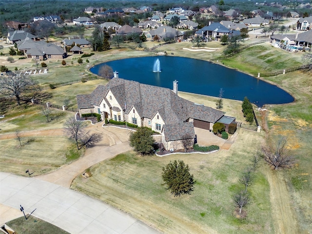 birds eye view of property featuring a water view and a residential view