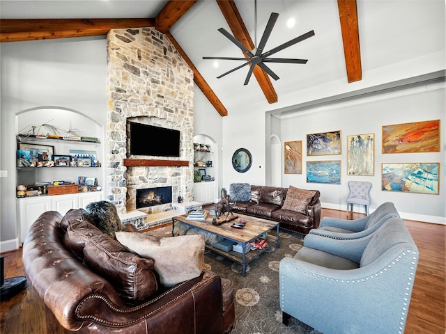 living room with baseboards, wood finished floors, beamed ceiling, a fireplace, and high vaulted ceiling