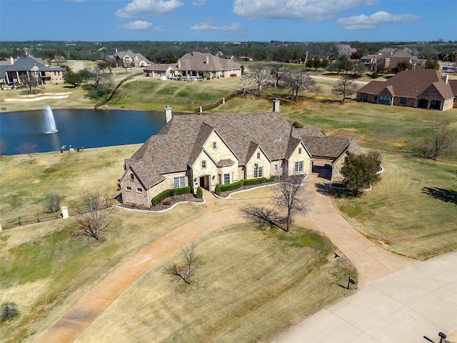 birds eye view of property with a water view and a residential view