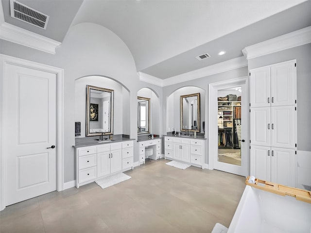 full bathroom featuring vaulted ceiling, ornamental molding, vanity, and visible vents