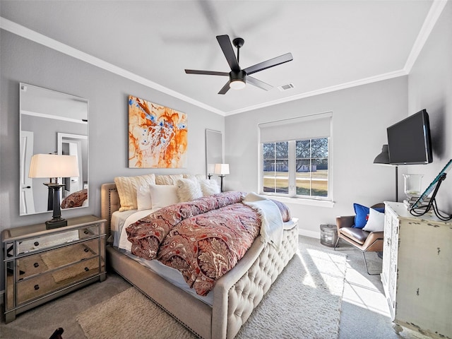 carpeted bedroom with baseboards, ceiling fan, visible vents, and crown molding