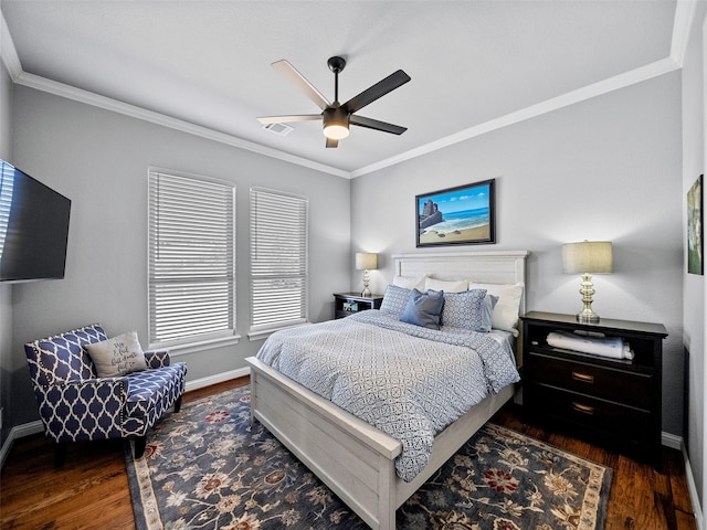 bedroom featuring baseboards, wood finished floors, visible vents, and crown molding