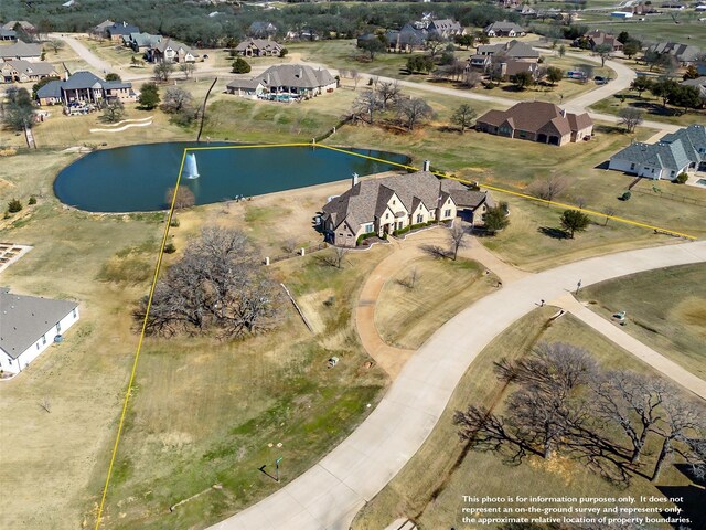 aerial view featuring a water view and a residential view