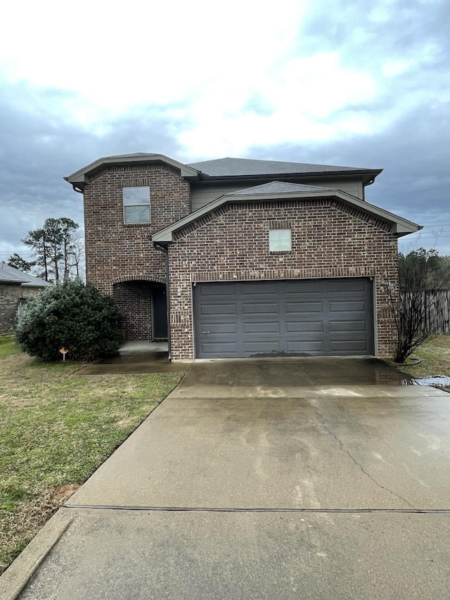 view of front of house featuring a front lawn, concrete driveway, brick siding, and an attached garage