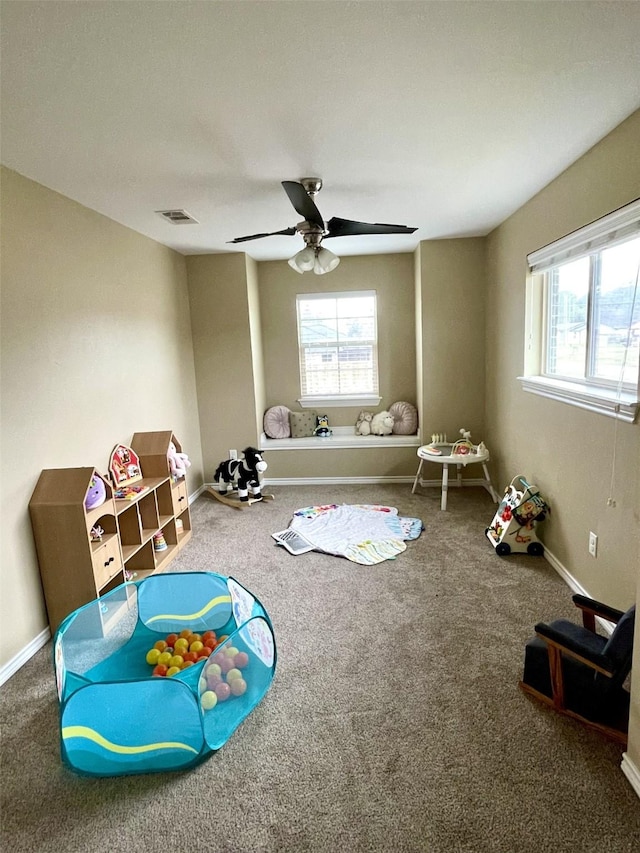 playroom featuring carpet floors, a healthy amount of sunlight, and visible vents