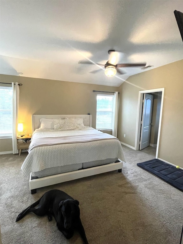 bedroom featuring carpet, visible vents, a textured ceiling, and baseboards