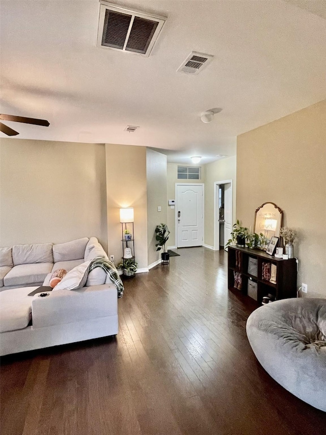 living room featuring visible vents, ceiling fan, baseboards, and hardwood / wood-style flooring