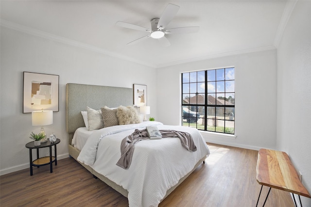 bedroom featuring crown molding, baseboards, ceiling fan, and wood finished floors