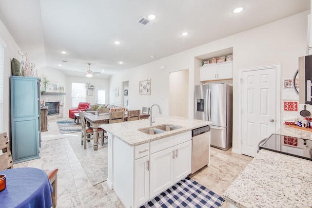 kitchen with white cabinetry, appliances with stainless steel finishes, a sink, and recessed lighting