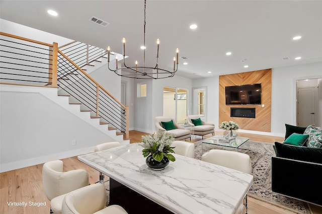 dining area with light wood finished floors, baseboards, visible vents, stairway, and recessed lighting