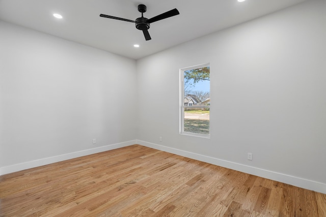 empty room featuring light wood-style floors, baseboards, and recessed lighting