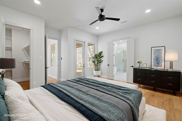 bedroom with light wood finished floors, visible vents, ensuite bathroom, and recessed lighting