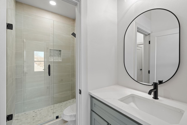 bathroom featuring a stall shower, vanity, toilet, and recessed lighting