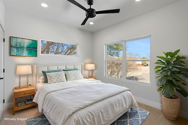 bedroom featuring light carpet, ceiling fan, recessed lighting, and baseboards