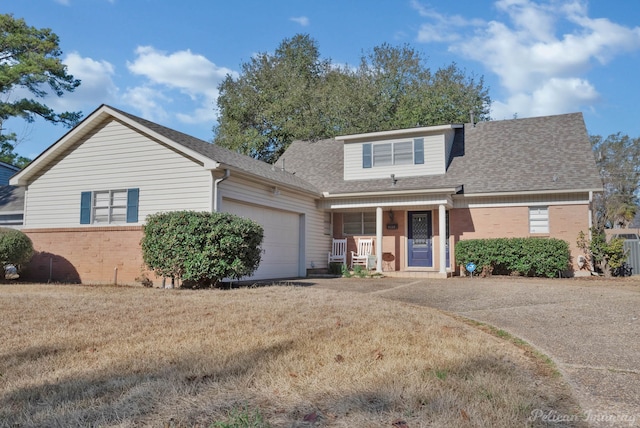 view of front of house featuring an attached garage, driveway, a shingled roof, and brick siding