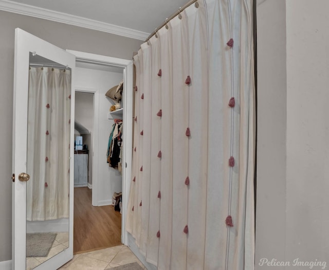 bathroom featuring tile patterned flooring and crown molding