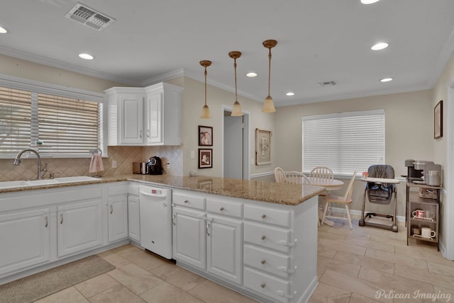 kitchen featuring a peninsula, white dishwasher, a sink, and visible vents