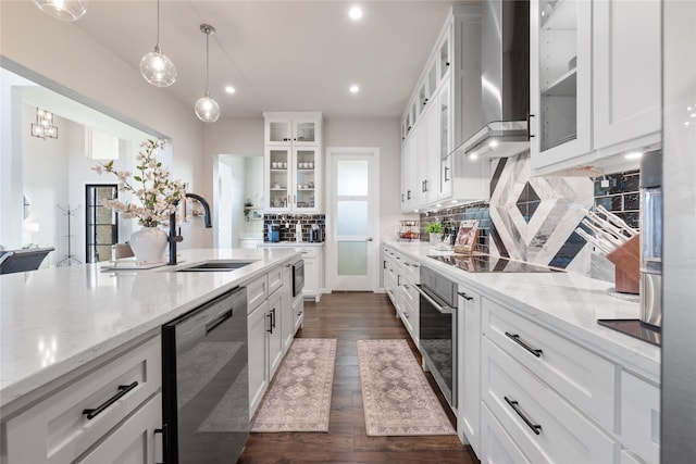 14402 Stice Rd, Krum, TX 76249 - kitchen with appliances with stainless steel finishes, wall chimney range hood, a sink, backsplash, and white cabinets