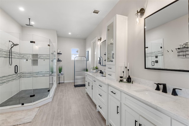 14402 Stice Rd, Krum, TX 76249 - bathroom with a stall shower, double vanity, and recessed lighting