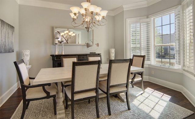 dining room with an inviting chandelier, crown molding, baseboards, and wood finished floors