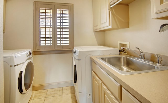 laundry area featuring cabinet space, plenty of natural light, washer and dryer, and a sink