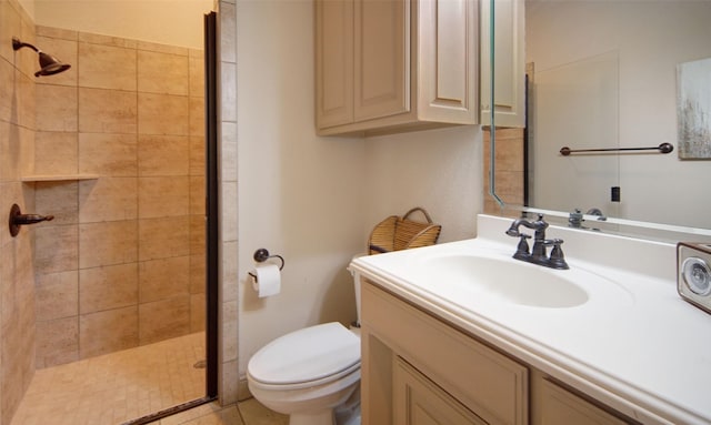 bathroom with a stall shower, vanity, and toilet