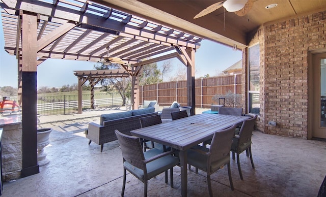 view of patio with outdoor dining area, ceiling fan, fence, and a pergola