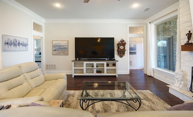 living area featuring visible vents, crown molding, and wood finished floors