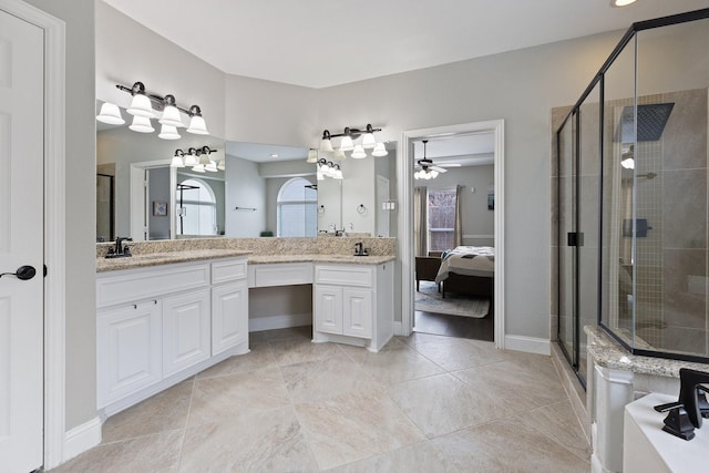 full bathroom featuring ensuite bathroom, a sink, a wealth of natural light, double vanity, and a stall shower